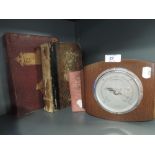 A vintage barometer and selection of books
