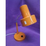 A vintage table top lamp in retro orange