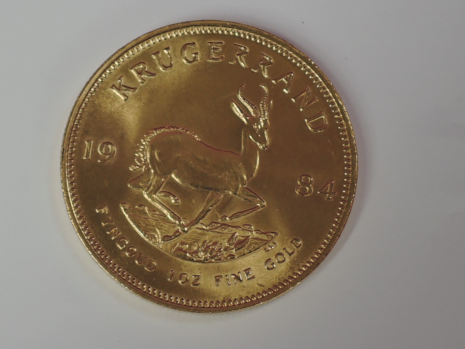 A gold 1oz 1984 South African Krugerrand coin, in plastic case