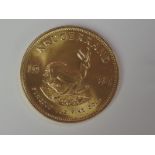 A gold 1oz 1984 South African Krugerrand coin, in plastic case