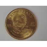 A gold 1oz 1987 South African Krugerrand coin, in plastic case