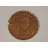 A gold 1oz 1980 South African Krugerrand coin, in plastic case
