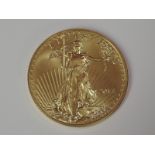 A gold 1oz 2014 50 dollar U.S.A. coin, in plastic case