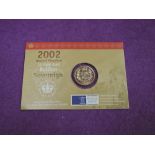 A gold 2002 UK bullion sovereign on card