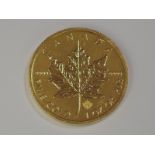 A gold 1oz 2014 Canada 50 dollar Maple leaf coin, in plastic case