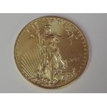 A gold 1oz 2017 50 dollar U.S.A. coin, in plastic case