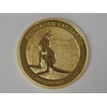 A gold 1oz 2014 100 dollar Australian Kangaroo coin, in plastic case