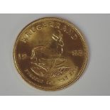 A gold 1oz 1983 South African Krugerrand coin, in plastic case