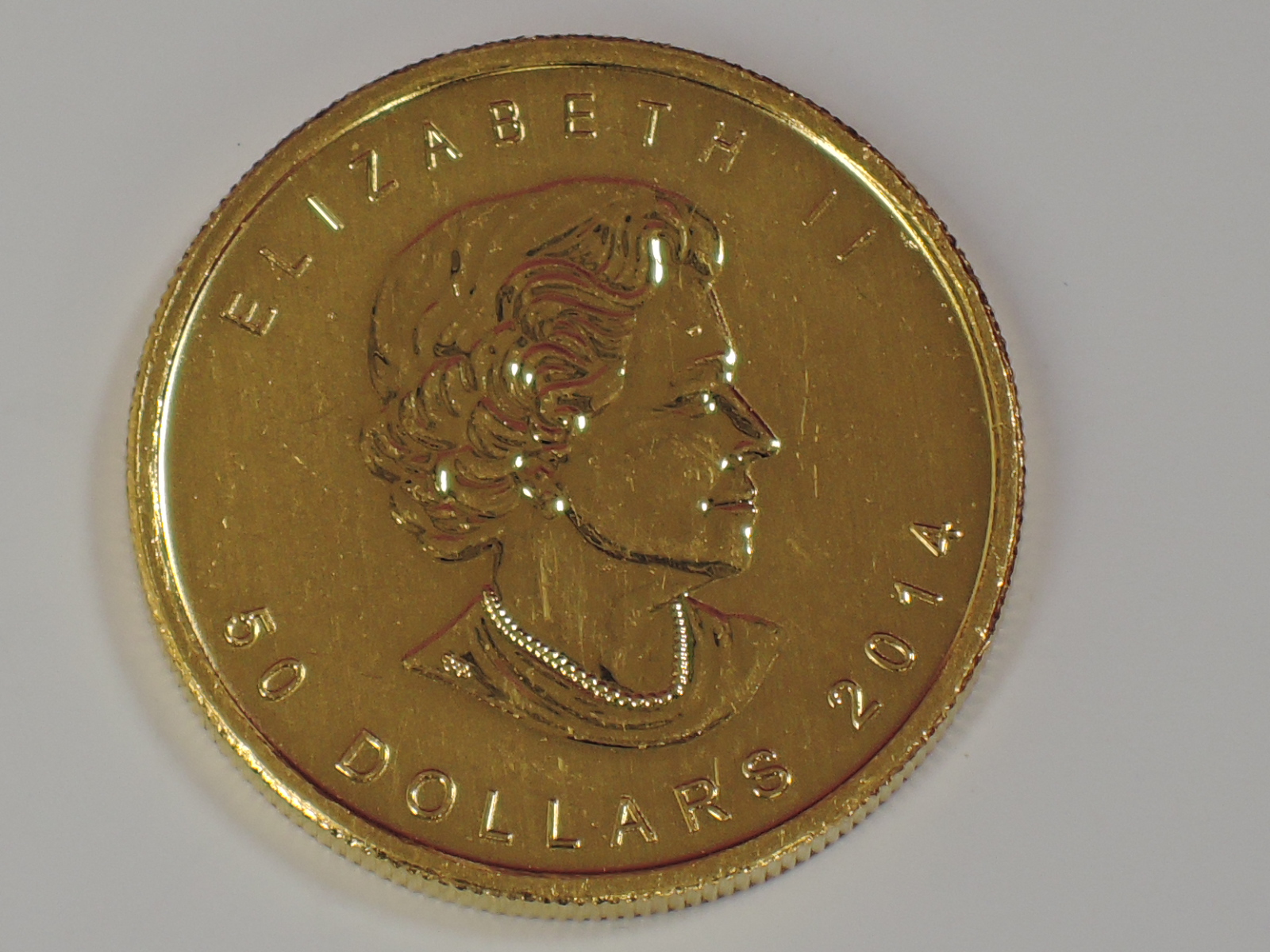 A gold 1oz 2014 Canada 50 dollar Maple leaf coin, in plastic case - Image 2 of 2