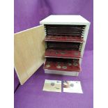 A collection of GB coins in a twenty-one drawer coin cabinet from 1p-£2 and two £20 silver GB coins