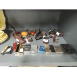 A selection of smokers pipes cigarette lighters etc