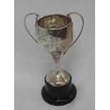 A silver two handled trophy of plain form with presentation inscription regarding children's