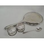 Four pieces of HM silver including a hand mirror of plain circular form with monogram to reverse,