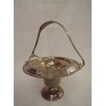 A white metal table basket of circular form stamped Sterling having fixed handle, pierced and