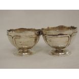 A pair of silver salts of circular form having shaped rim and applique tube decoration, no liners,