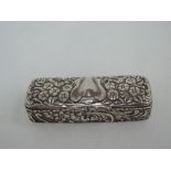 A small Edwardian silver trinket box of rectangular form having hinged lid and extensive repousse