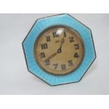 A silver travel clock of octagonal form having turquoise guilloche enamel decoration and an 8 day