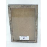 A small silver photograph frame of plain rectangular form having wooden easel stand, Birmingham