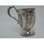 A Victorian silver tankard having moulded beaded handle, repousse swag panels and a beaded