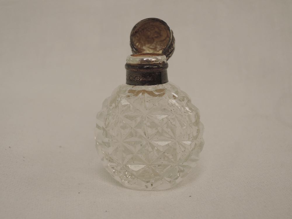 A small Victorian cut class scent bottle having moulded decoration to silver lid, (no stopper),