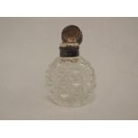 A small Victorian cut class scent bottle having moulded decoration to silver lid, (no stopper),