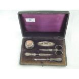 A small cased five piece silver handled manicure set, Birmingham 1921, Boots Pure Drug Company