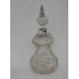 An Edwardian cut glass waisted bottle having silver tipped stopper and collar, London 1907,