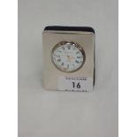 A small silver travel clock by Kitney & Co having a Roman numeral dial to circular face in plain