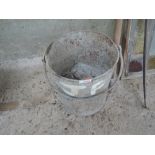 A galvanised bucket containing vintage hammer heads