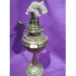 A vintage brass bodied oil burning lamp