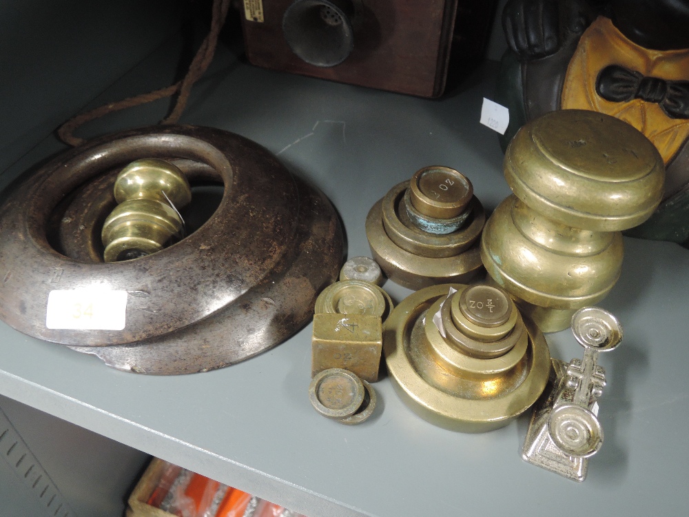 A selection of vintage brass and cast weights in various designs