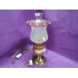 A vintage converted oil burning lamp with etched and pink frosted shade
