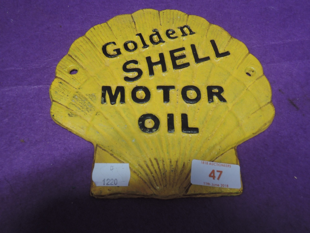 A vintage cast Motor oil advertising sign for garage fore court Golden Shell repainted