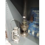 A vintage Super Aladdin oil burning lamp and similar storm lantern