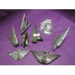 A selection of vintage hood ornaments and car badges and decorations