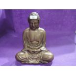 A large Buddah figure sat in meditation with gilt glaze