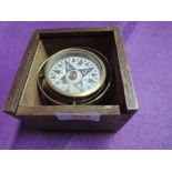 A vintage compass with brass body held in gimble and oak case