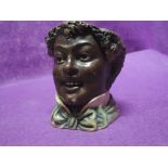 A vintage ceramic figure head in a Black a moor style stamped 338 to base