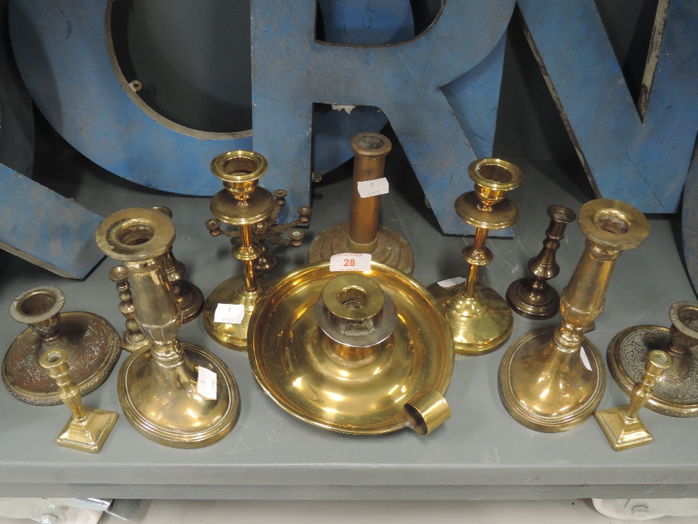 A selection of vintage brass cast candle and chamber sticks