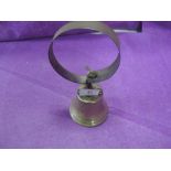 A vintage brass door bell with spring mechanism