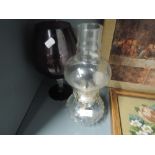 A vintage purple glass vase with twist stem and oil burning lamp