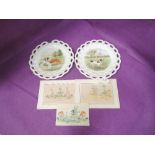 A pair of Edwardian ribbon plates having pictorial dog decoration by R Seddon and three fairy