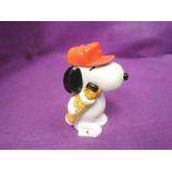 A vintage ceramic figure of Snoopy dog as golf caddy stamped 1958,1966