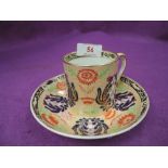 An early 19th century porcelain cabinet cup and saucer, having gilt heightened floral decoration,