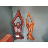 A pair of vintage nude female figures in yoga pose dark and light woods