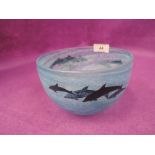 A blue glass bowl with dolphin print