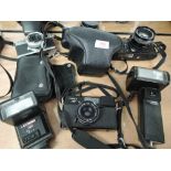 Four cameras and two flash guns, a Canon Canonet 28, a Pentax K1000, a Konica Autoreflex TC, a