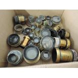 A box of various brass lenses, including Ross, Casket, W Watson & Son, Taylor Hobson - Cooke, Ada