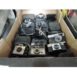 A box of mainly Instamatic cameras