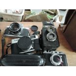 Four cameras, including a Canon QL, a Miranda FV, a Voigtlander Brillant, and a Condor 1